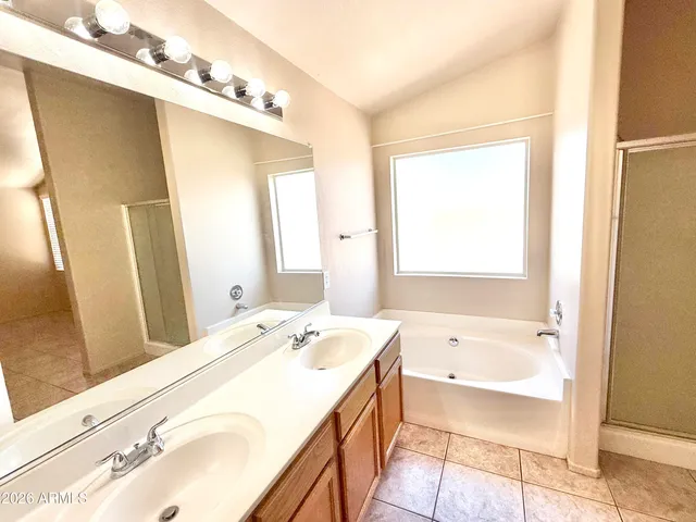 a bathroom with a tub and a shower