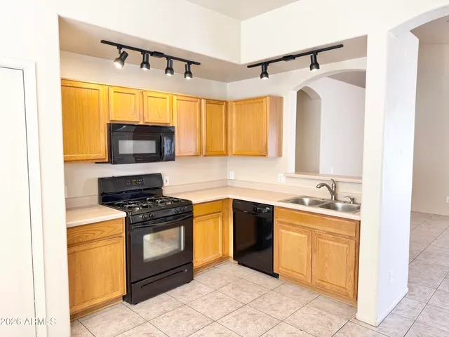 a kitchen with a sink stove and microwave