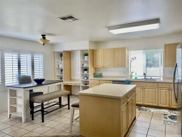 a kitchen with a stove a sink and a refrigerator