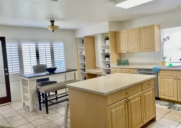 a kitchen with a sink cabinets and window
