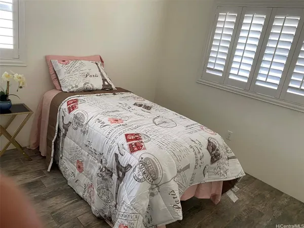 a bed sitting in a bedroom next to a window