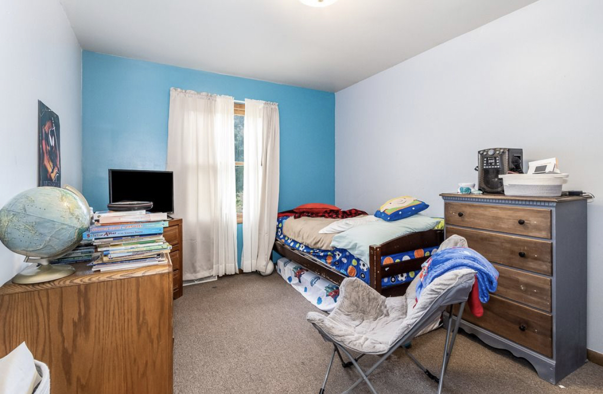 1943 Church Road Aurora, IL 60505 - Photo 21 of 31 a bedroom with a bed and flat screen tv
