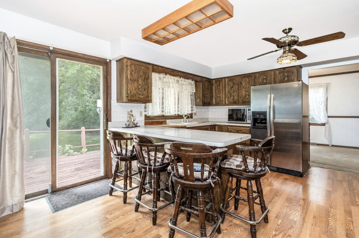 1943 Church Road Aurora, IL 60505 - Photo 3 of 31 a kitchen with stainless steel appliances granite countertop a dining table chairs refrigerator and sink
