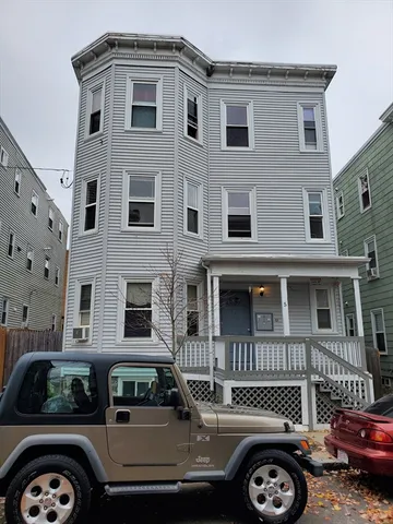 a front view of a house with parking space