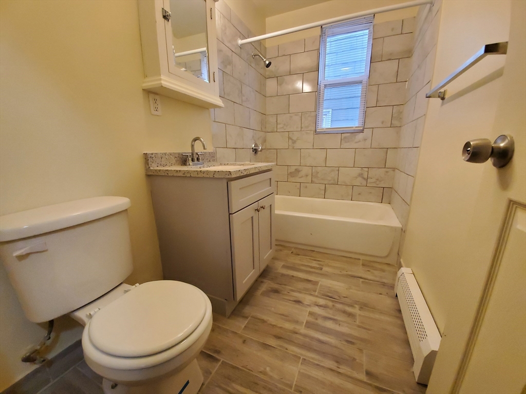 5 Coleman Street, Unit 2 Boston, MA 02125 - Photo 4 of 9 a bathroom with a sink a toilet and shower