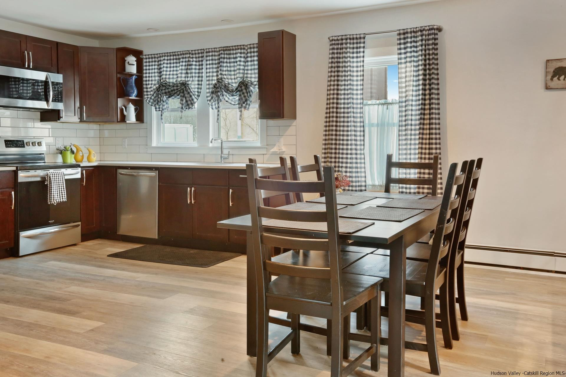 7732 Main Street Hunter, NY 12442 - Photo 11 of 25 a kitchen with a table chairs sink and microwave