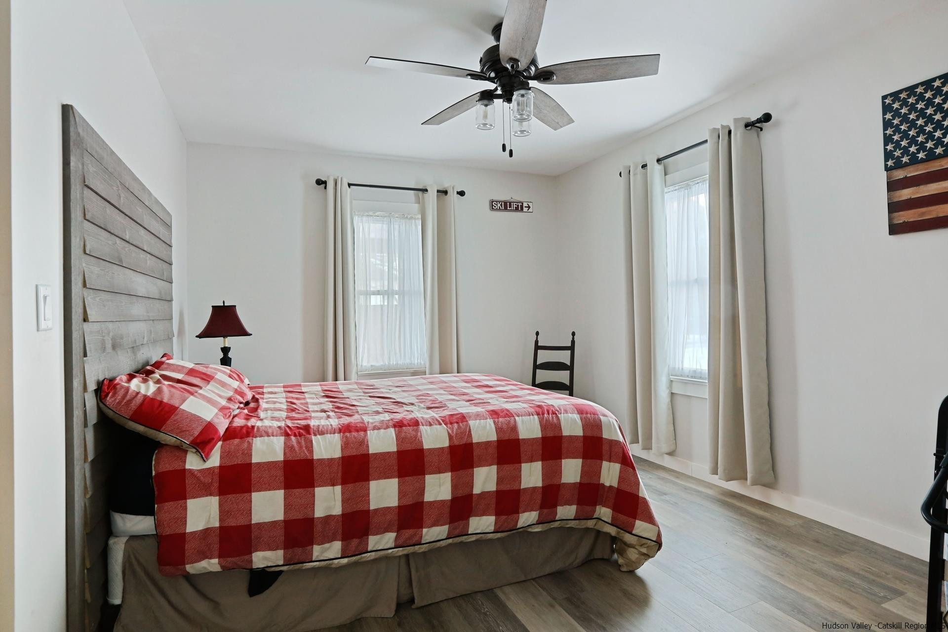 7732 Main Street Hunter, NY 12442 - Photo 12 of 25 a bedroom with a bed and wooden floor