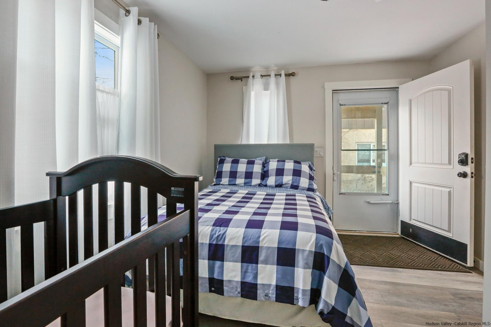 7732 Main Street Hunter, NY 12442 - Photo 16 of 25 a bedroom with a bed and wooden floor