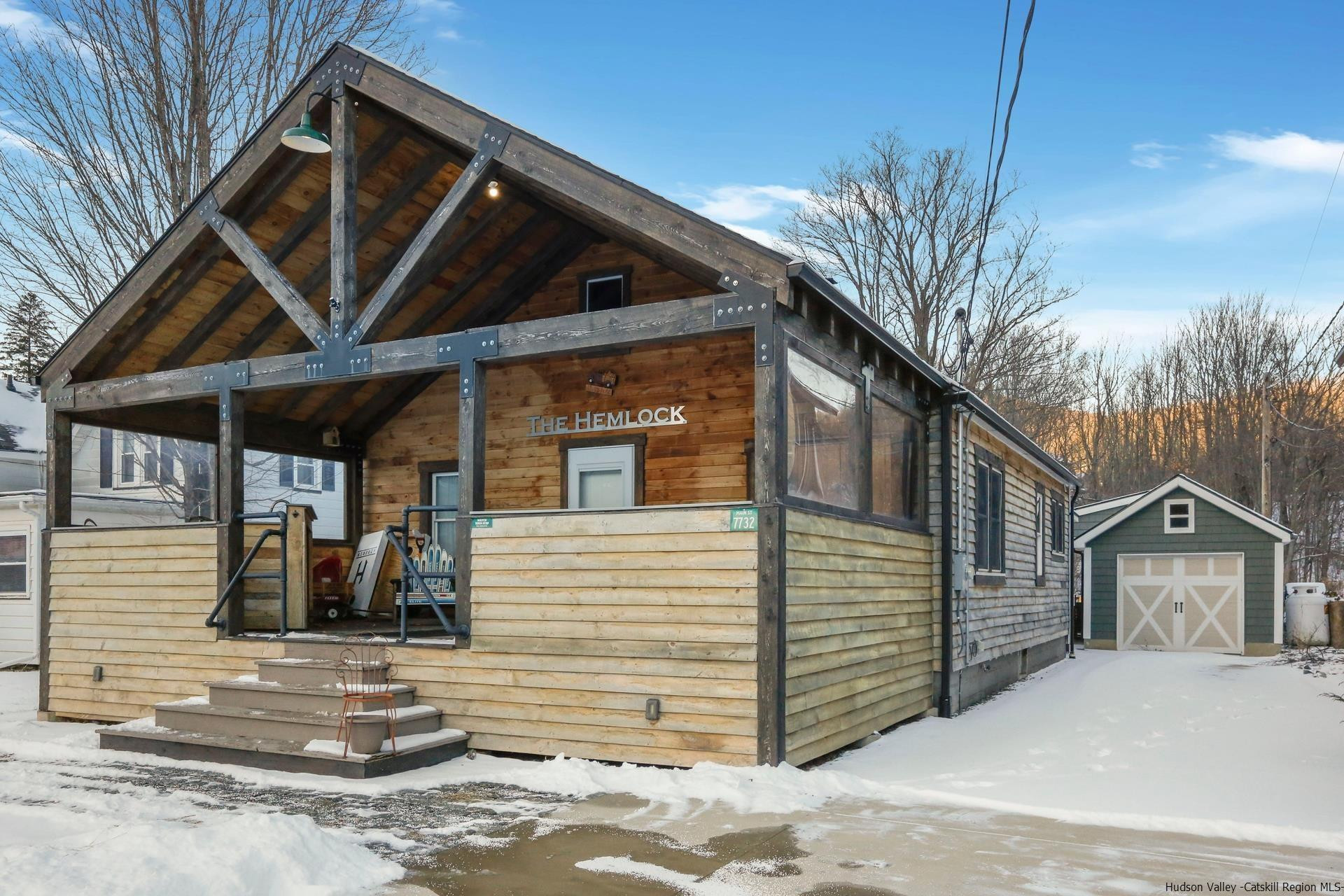 7732 Main Street Hunter, NY 12442 - Photo 20 of 25 a front view of a house with a tree