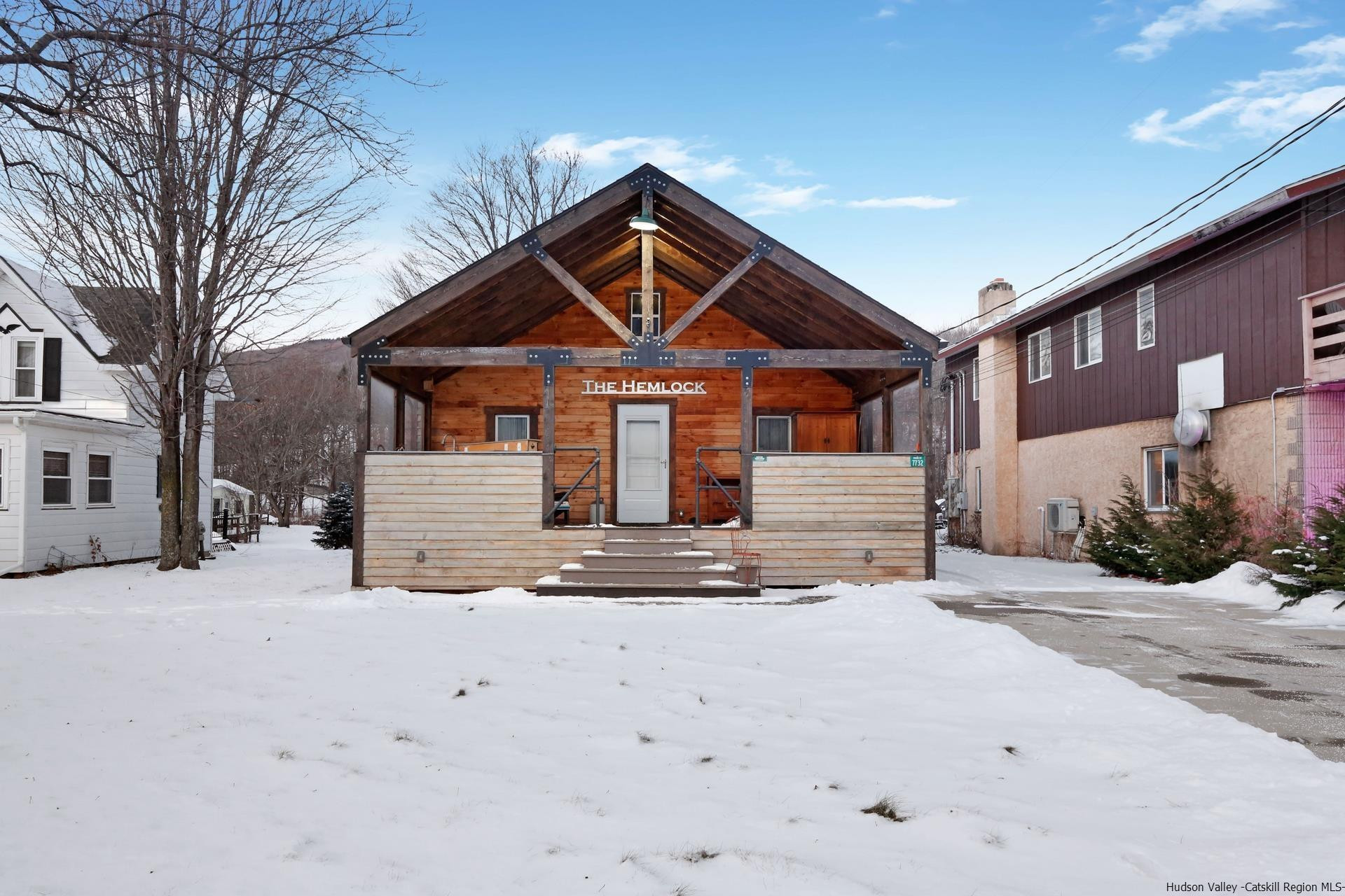 7732 Main Street Hunter, NY 12442 - Photo 21 of 25 a front view of a house with a yard and garage