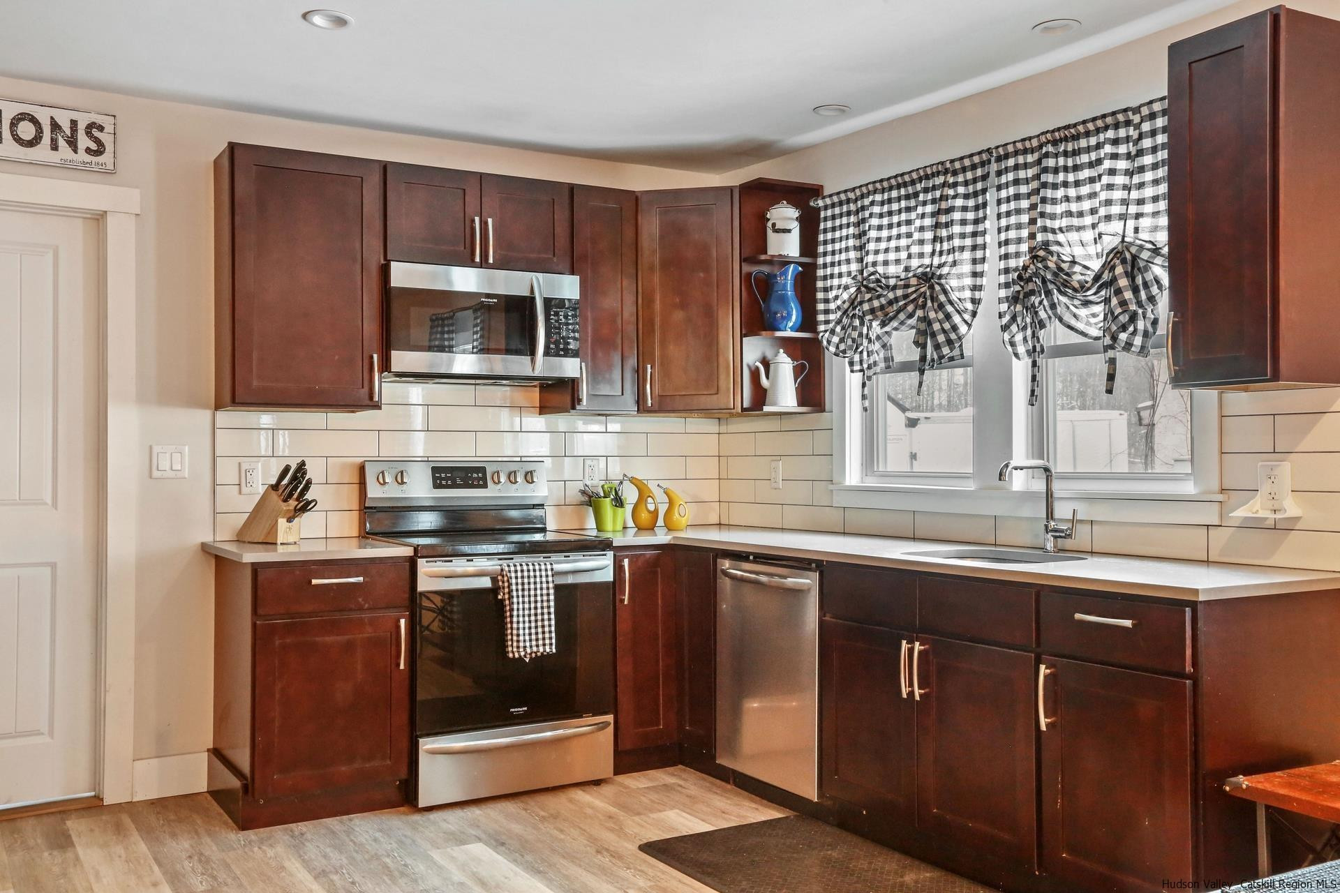 7732 Main Street Hunter, NY 12442 - Photo 4 of 25 a kitchen with stainless steel appliances granite countertop a sink stove and microwave