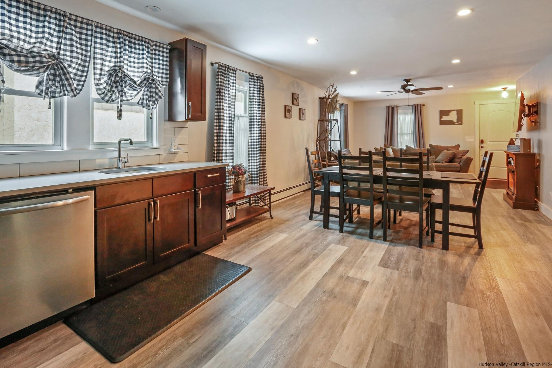 7732 Main Street Hunter, NY 12442 - Photo 6 of 25 a large kitchen with lots of wooden furniture a sink and a dining table