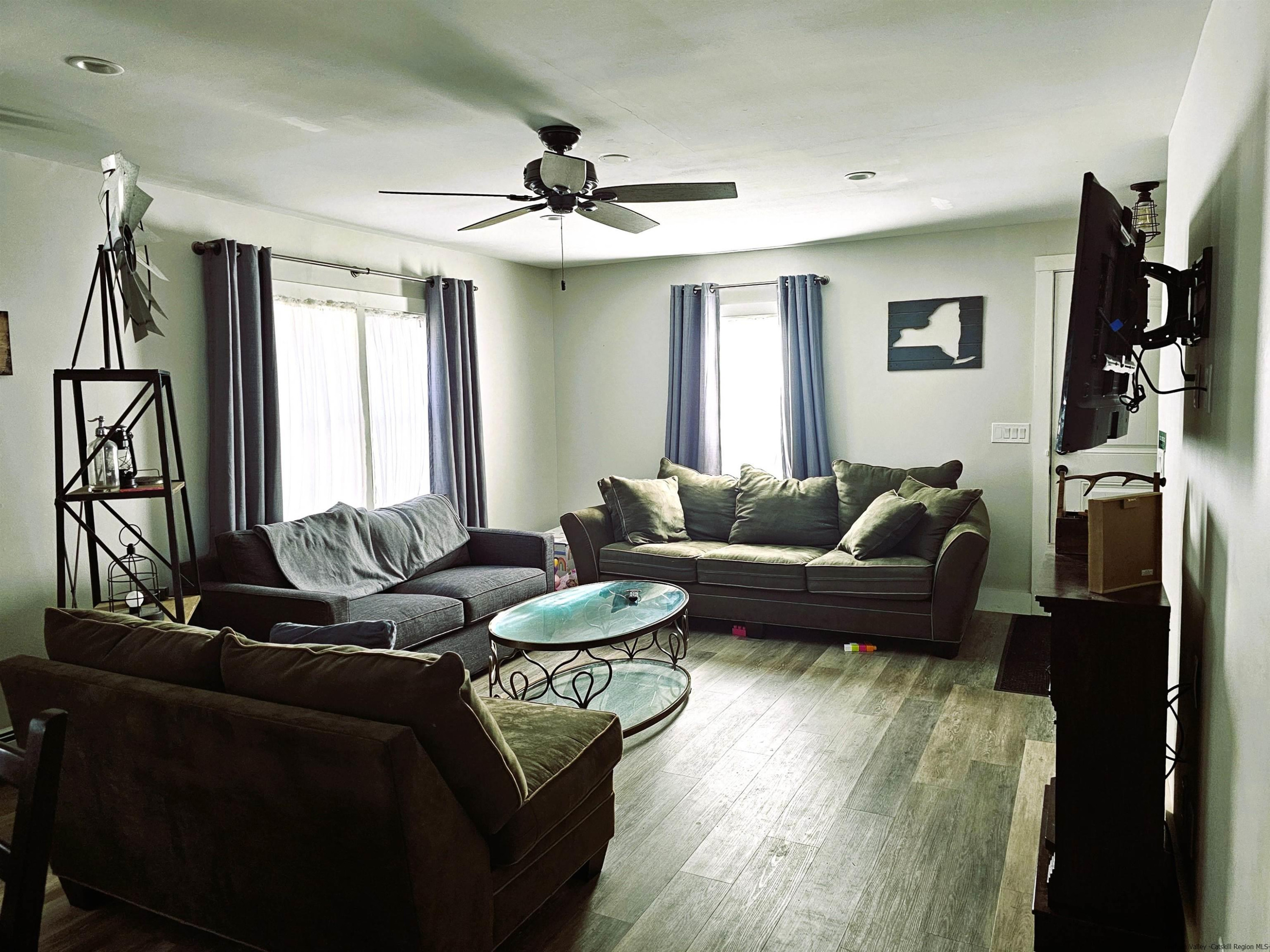 7732 Main Street Hunter, NY 12442 - Photo 9 of 25 a living room with furniture and a flat screen tv