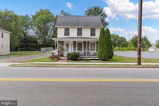 a view of a house with a swimming pool and a yard