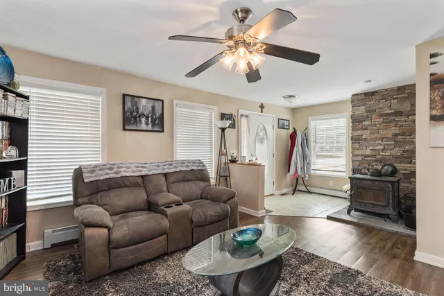 a living room with furniture a rug and a window