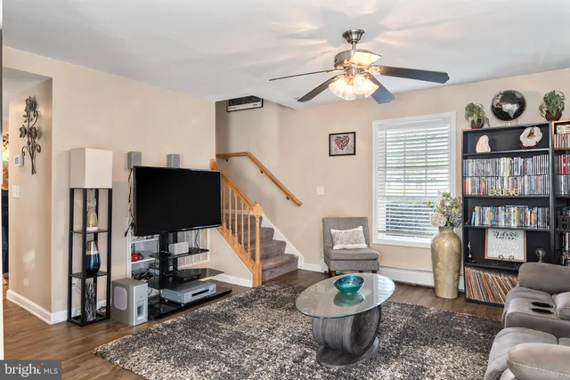 a living room with furniture and a book shelf