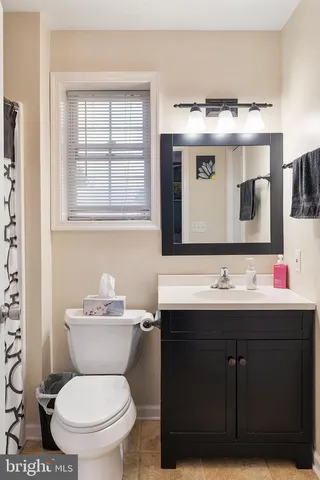 a bathroom with a sink toilet and mirror