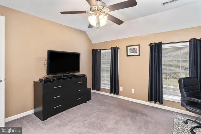 a bathroom with a granite countertop sink a mirror and a shower