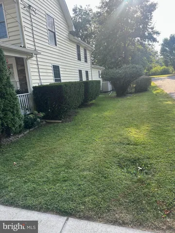 a view of a house with backyard and wooden deck