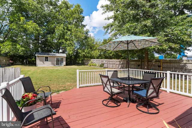 a view of a livingroom with workspace and a window