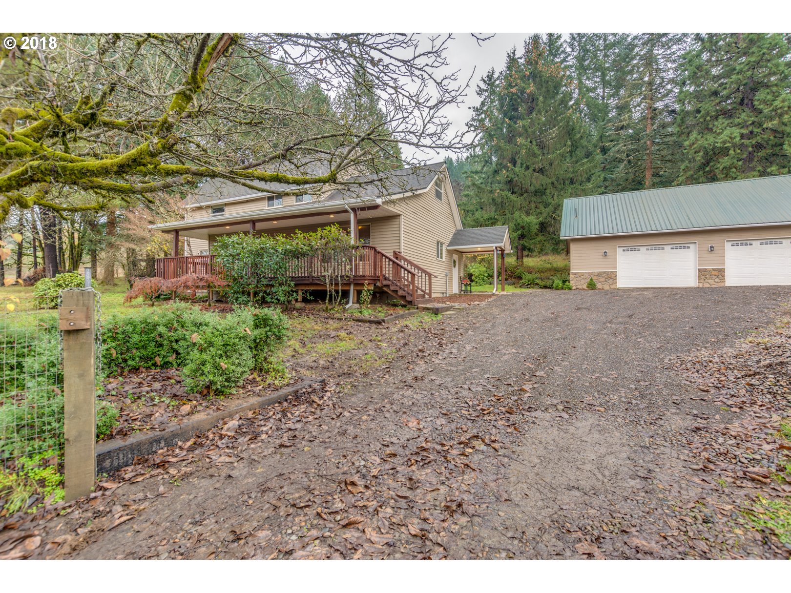 49572 Southwest South Road Gaston, OR 97119 - Photo 1 of 32 a backyard of a house with large trees and a barn