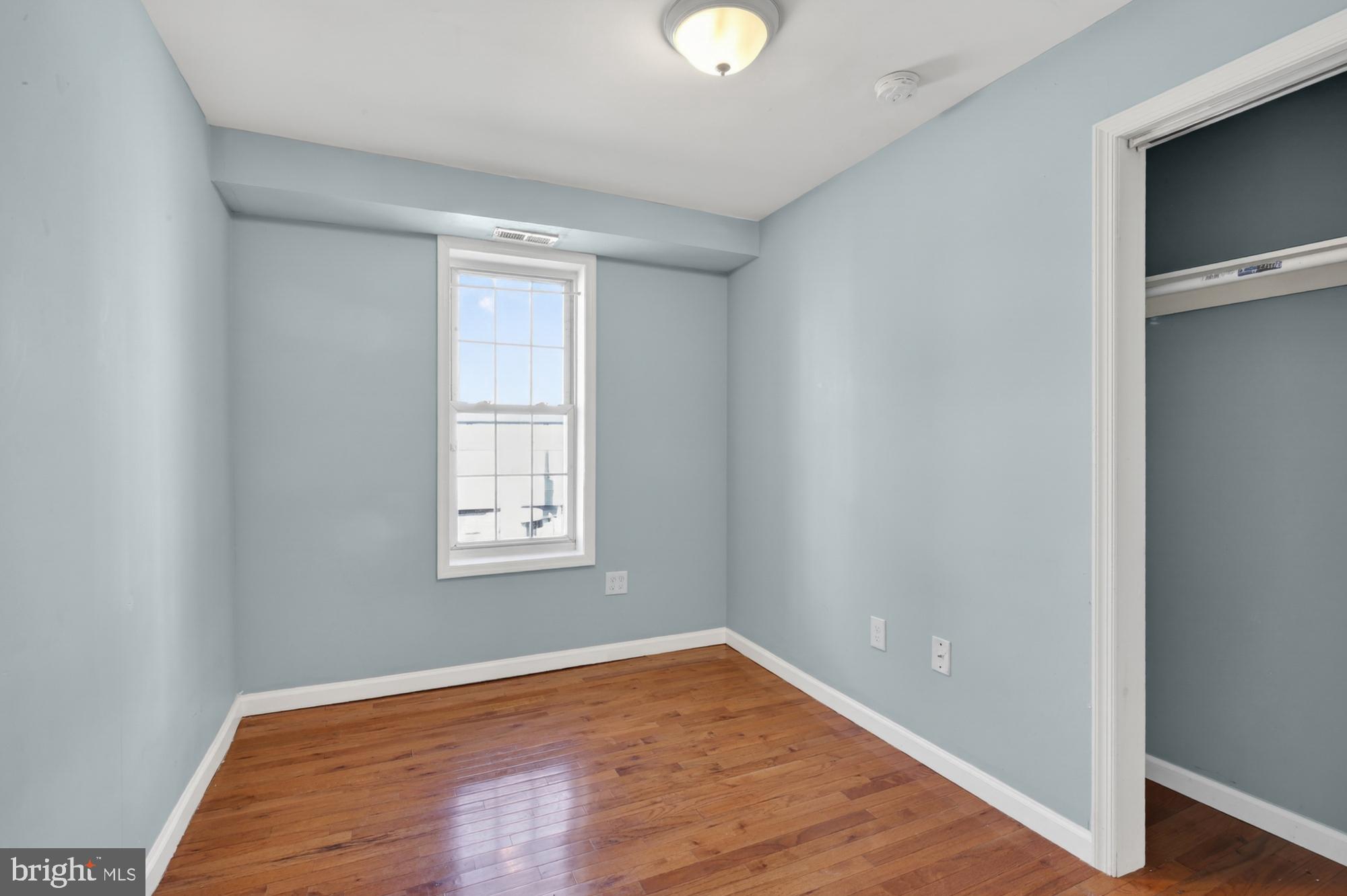 1400 South Chadwick Street, Unit 2 Philadelphia, PA 19146 - Photo 11 of 20 an empty room with wooden floor and windows