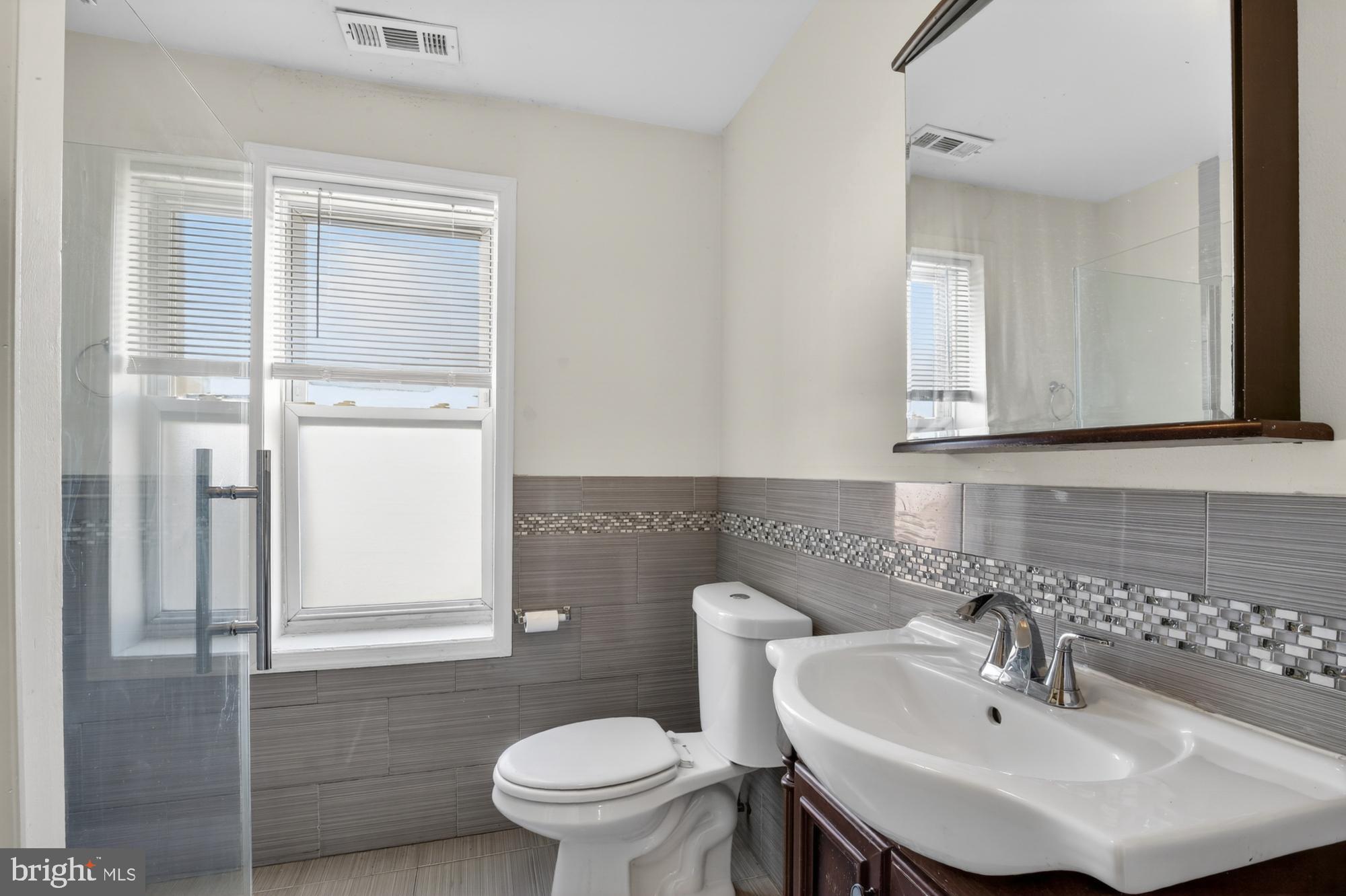 1400 South Chadwick Street, Unit 2 Philadelphia, PA 19146 - Photo 13 of 20 a bathroom with a sink toilet and a mirror
