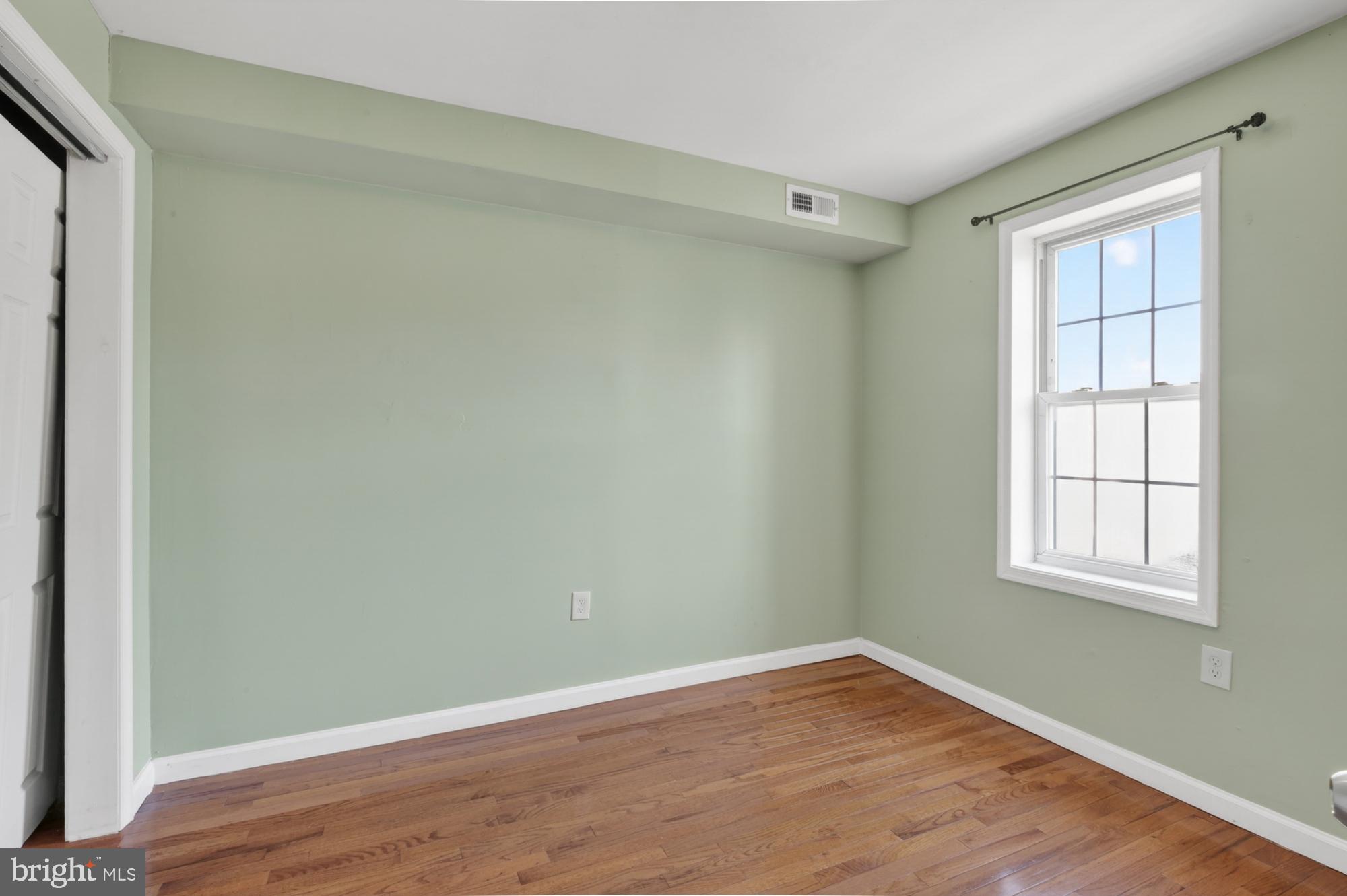 1400 South Chadwick Street, Unit 2 Philadelphia, PA 19146 - Photo 15 of 20 an empty room with wooden floor and windows