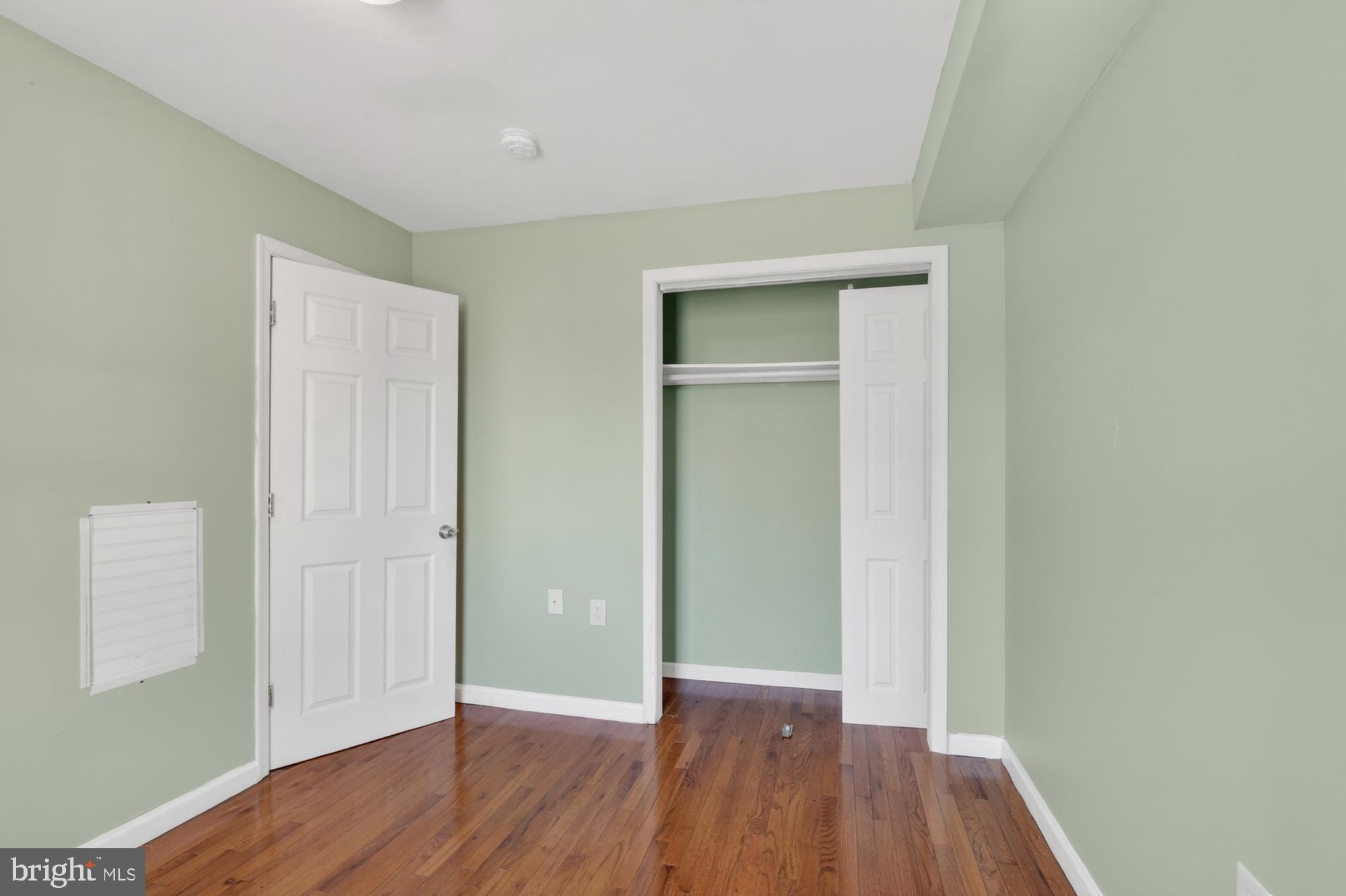 1400 South Chadwick Street, Unit 2 Philadelphia, PA 19146 - Photo 17 of 20 an empty room with wooden floor and closet