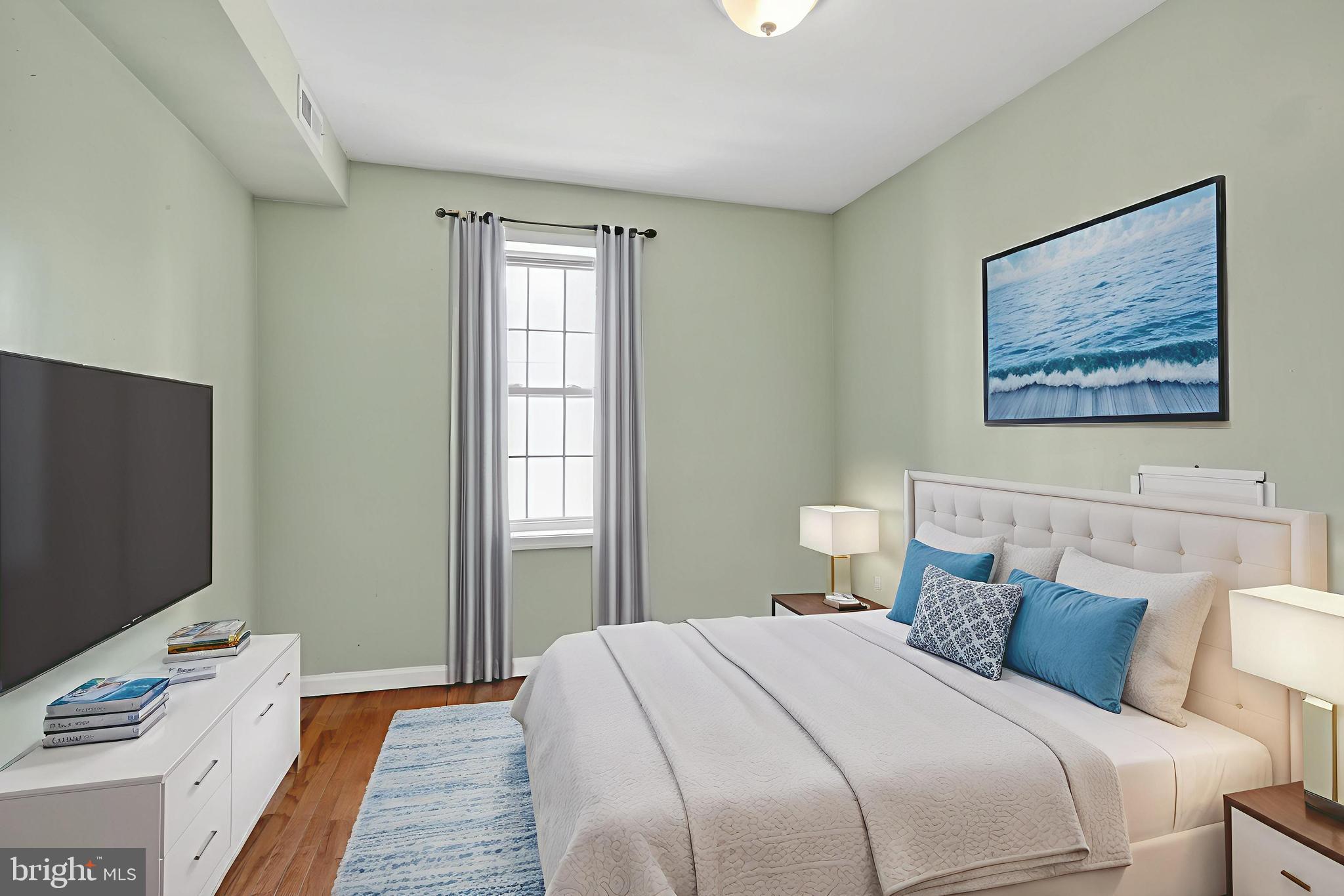 1400 South Chadwick Street, Unit 2 Philadelphia, PA 19146 - Photo 2 of 20 a bedroom with a bed and a flat screen tv