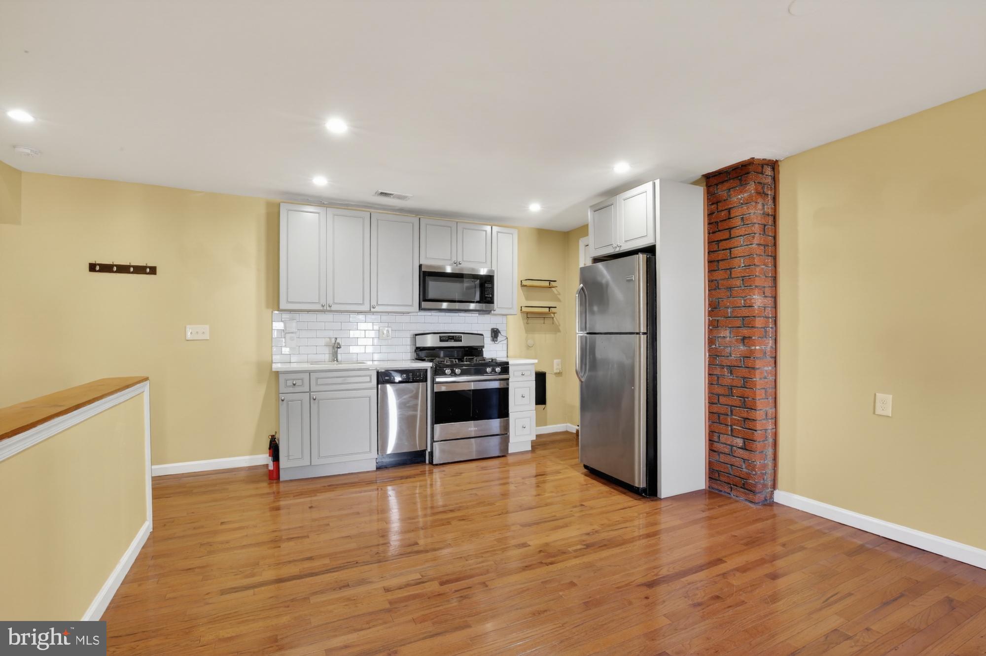 1400 South Chadwick Street, Unit 2 Philadelphia, PA 19146 - Photo 3 of 20 a kitchen with a refrigerator and a stove top oven