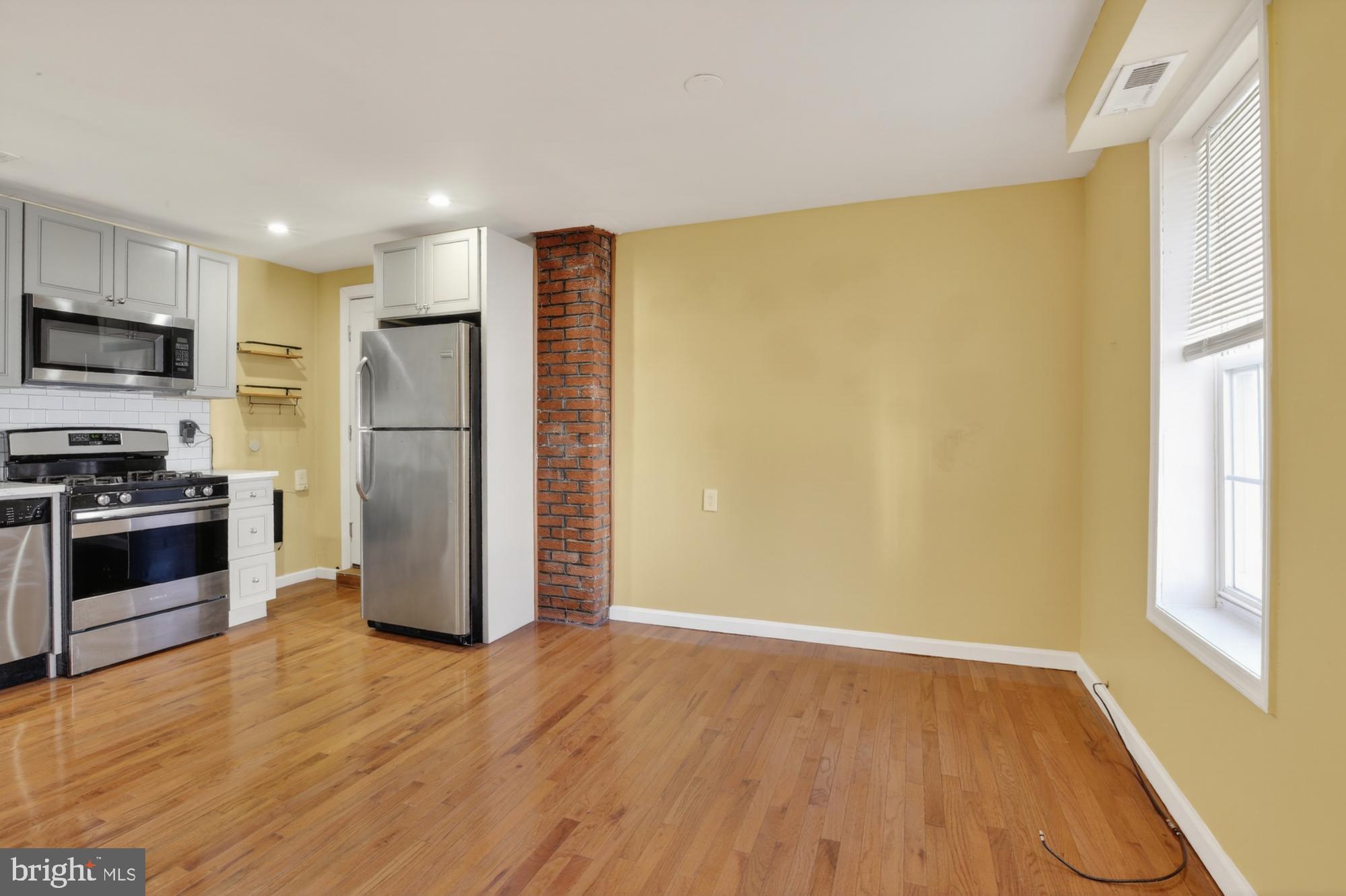 1400 South Chadwick Street, Unit 2 Philadelphia, PA 19146 - Photo 8 of 20 a view of kitchen with stainless steel appliances wooden floor and window