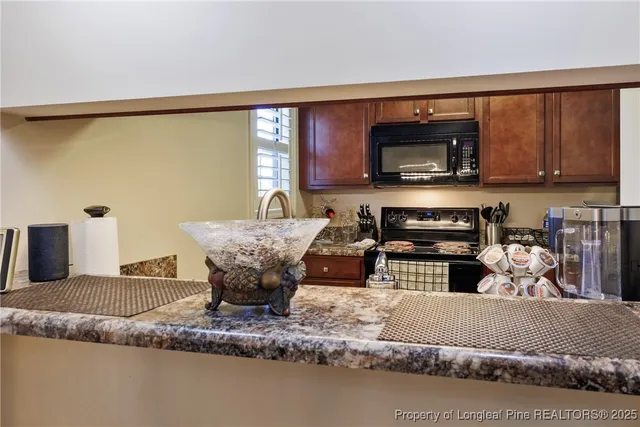 a kitchen with a stove a sink and a microwave