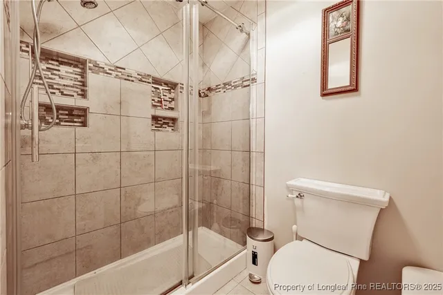 a white toilet sitting next to a bathtub