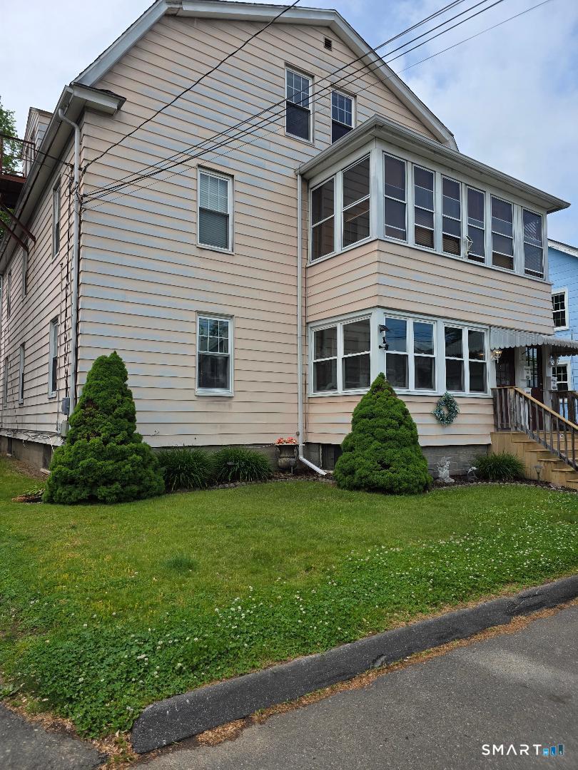 103 Windsor Street Enfield, CT 06082 - Photo 2 of 22 a front view of a house with a garden