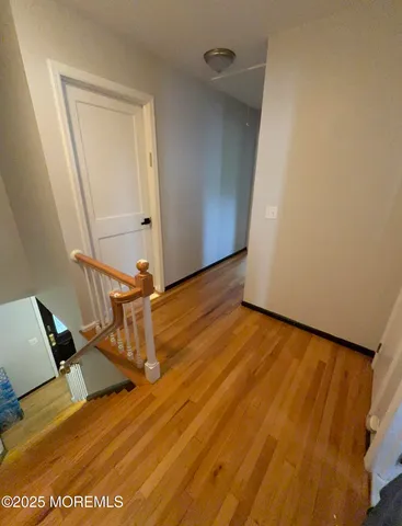 a view of a room with wooden floor