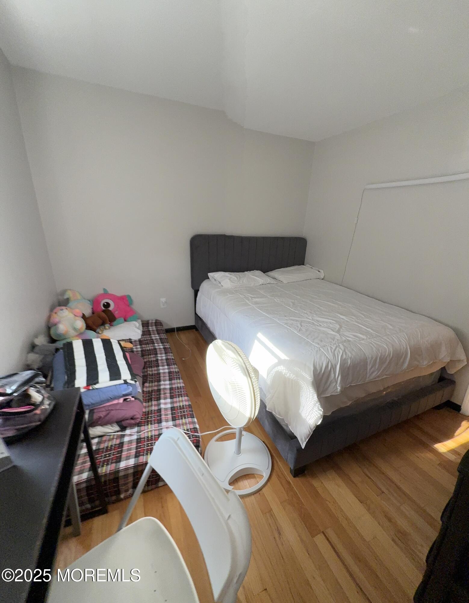 241 Cliftwood Road Oakhurst, NJ 07755 - Photo 19 of 27 a bedroom with a bed and a table in it