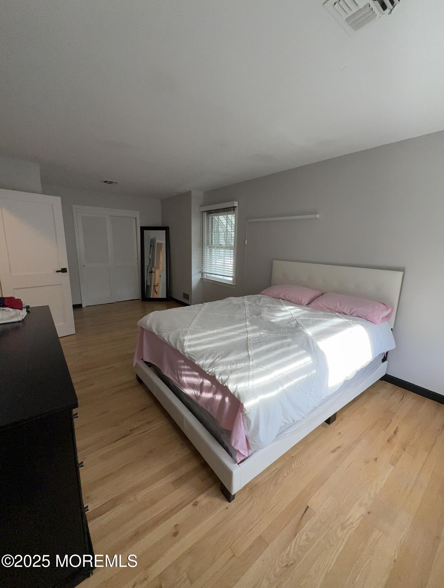 241 Cliftwood Road Oakhurst, NJ 07755 - Photo 24 of 27 a bedroom with a bed and a night stand