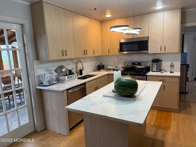 a kitchen with a sink a stove and cabinets