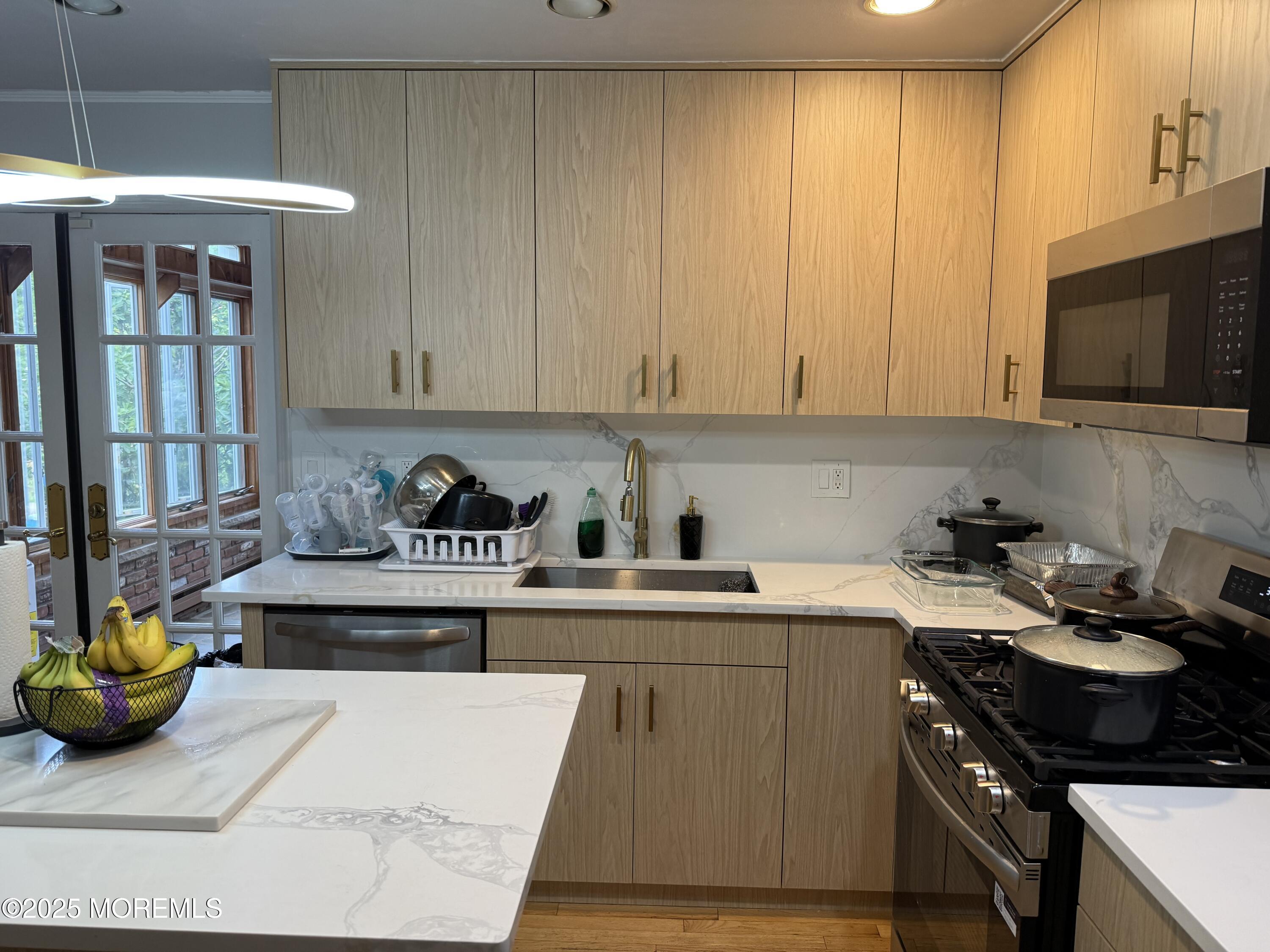 241 Cliftwood Road Oakhurst, NJ 07755 - Photo 6 of 27 a kitchen with stainless steel appliances granite countertop a stove and a white cabinets