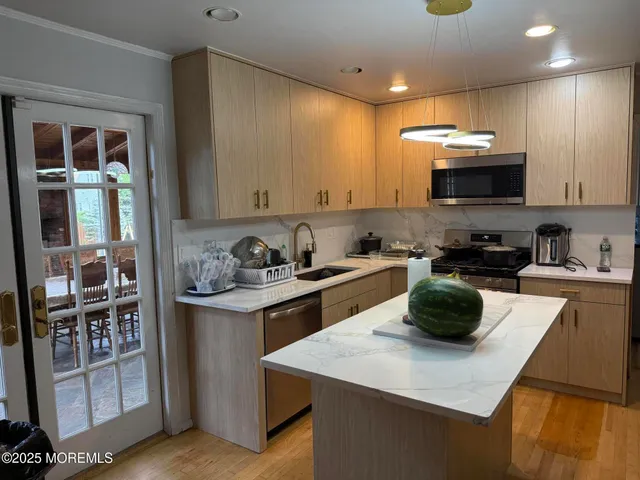 a kitchen with a sink a stove and cabinets