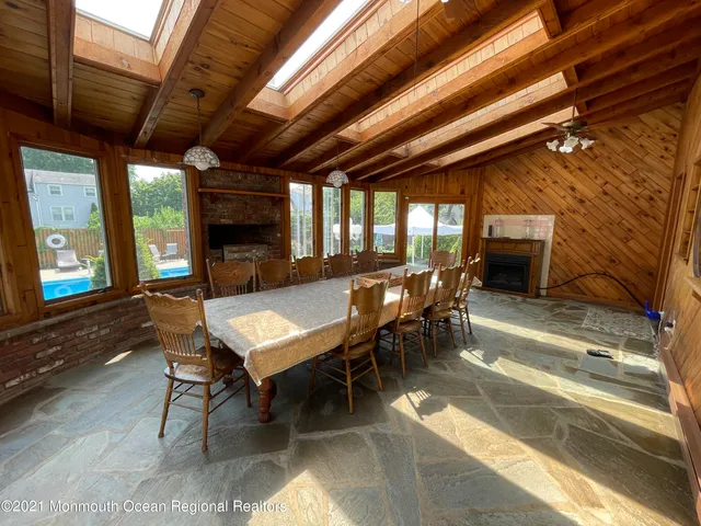 a dining room with furniture a fireplace and wooden floor