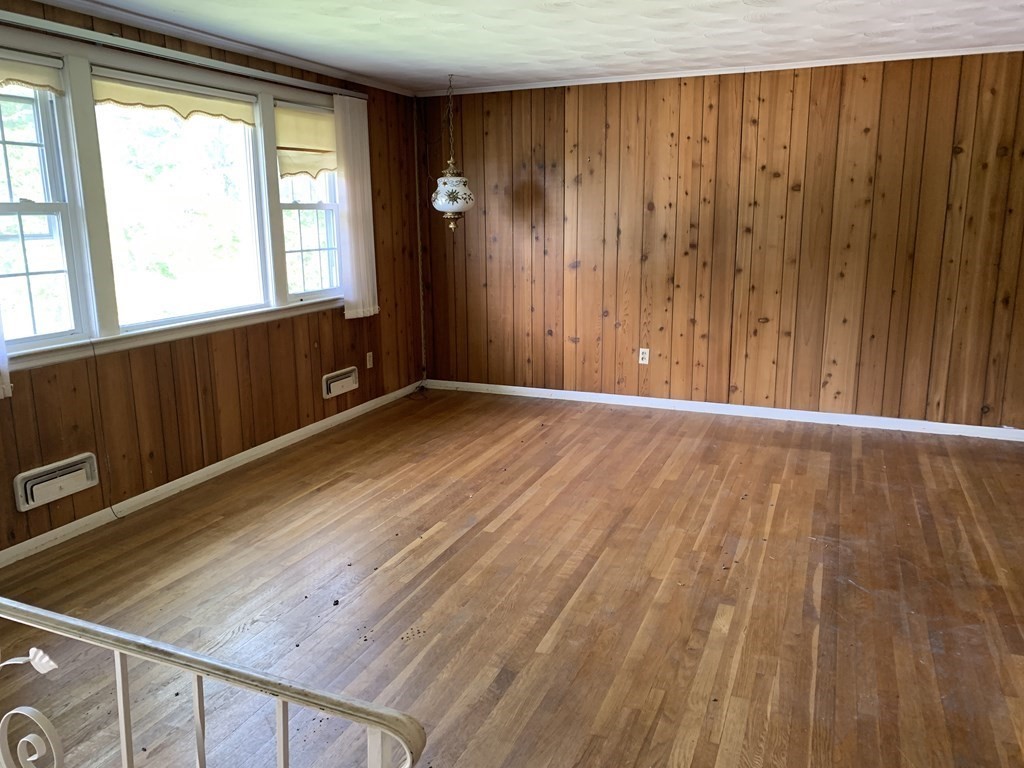 22 Redman Road Canton, MA 02021 - Photo 2 of 13 a view of an empty room with wooden floor and a window