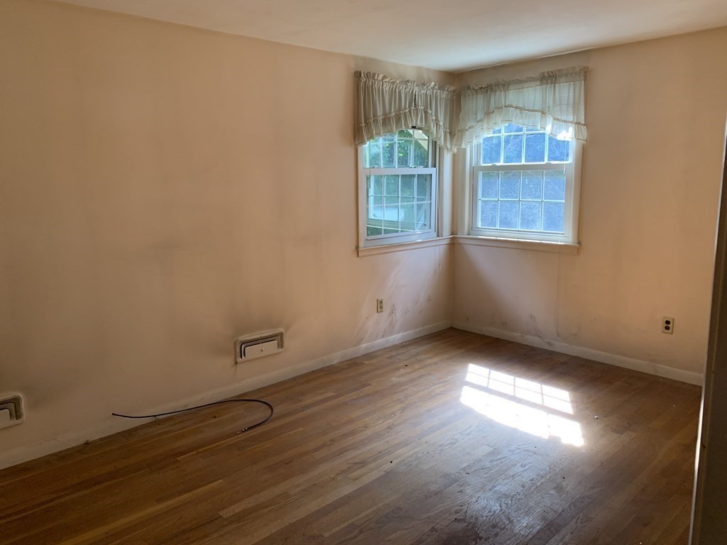 22 Redman Road Canton, MA 02021 - Photo 6 of 13 an empty room with wooden floor and windows