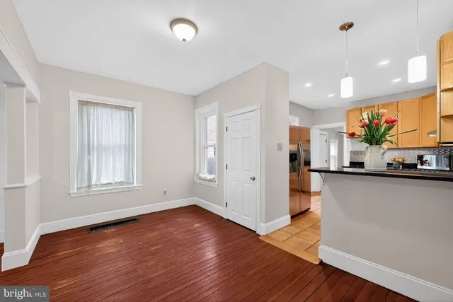 a view of a kitchen with wooden floor and a window
