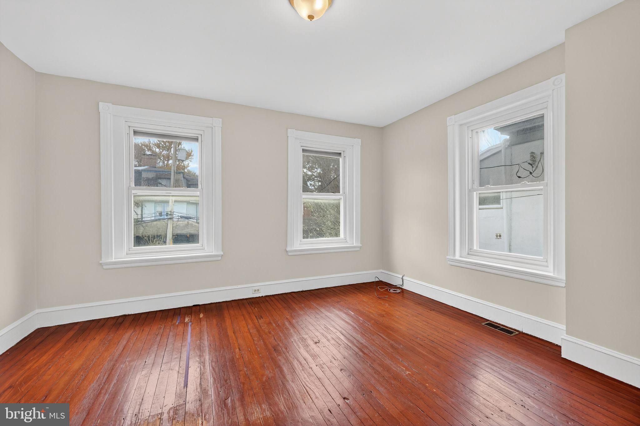 5443 Morris Street Philadelphia, PA 19144 - Photo 23 of 37 a view of an empty room with wooden floor and a window