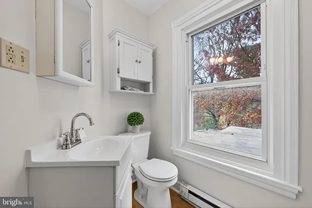 a bathroom with a toilet sink and mirror