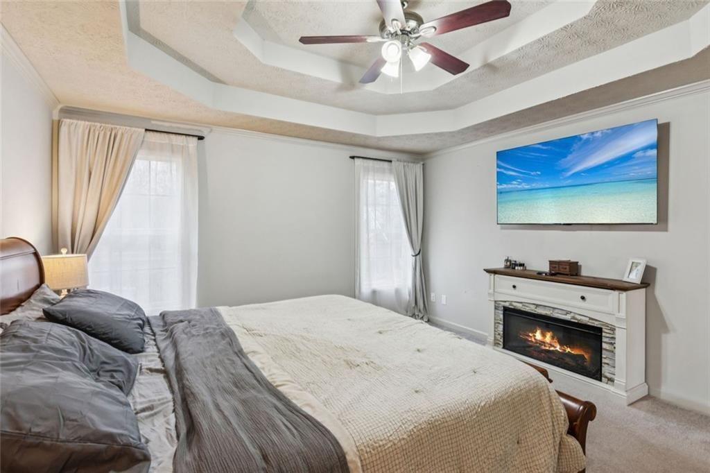 5595 Vaughn Road Woodstock, GA 30188 - Photo 19 of 42 a bedroom with a bed and a chandelier