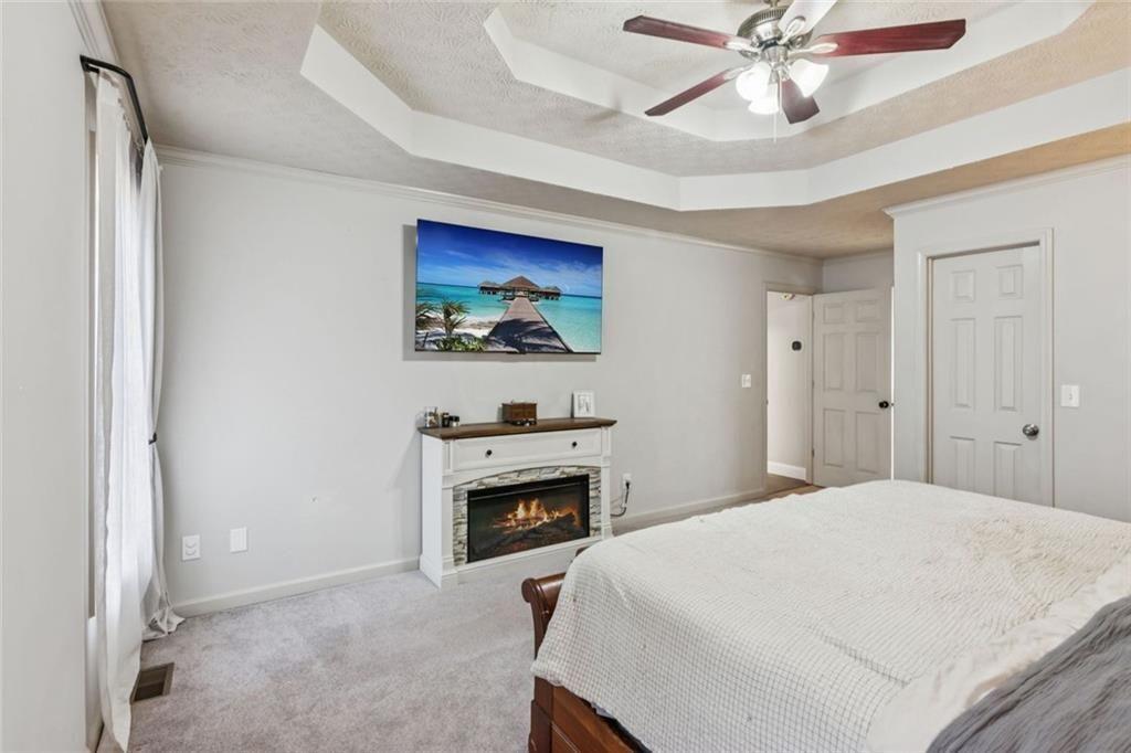 5595 Vaughn Road Woodstock, GA 30188 - Photo 20 of 42 a bedroom with a bed and a chandelier