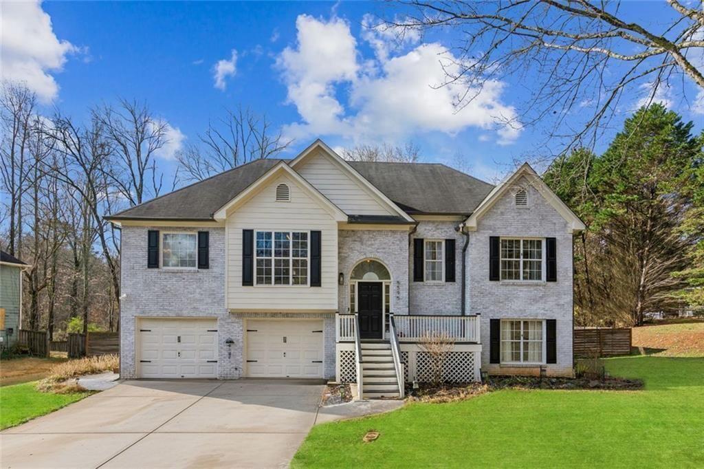 5595 Vaughn Road Woodstock, GA 30188 - Photo 2 of 42 front view of house with a yard